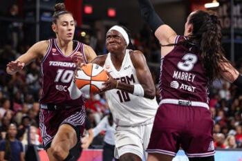 Aug 10, 2026; College Park, Georgia, USA; Atlanta Dream guard Rhyne Howard (10) drives to the basket against Toronto Tempo forward Maria Conde (10) and guard Marina Mabrey (3) in the second quarter at Gateway Center Arena at College Park. Mandatory Credit: Colin Hubbard-Imagn Images