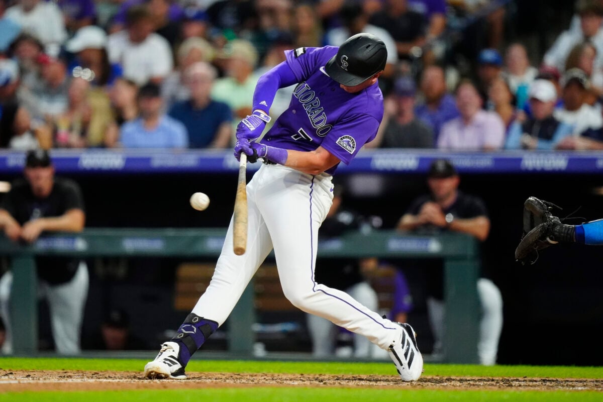 Aug 19, 2026; Denver, Colorado, USA; Colorado Rockies first baseman TJ Rumfield (7) singles in the fourth inning against the Los Angeles Dodgers at Coors Field. Mandatory Credit: Ron Chenoy-Imagn Images