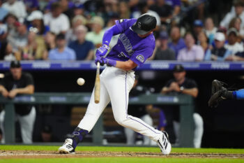 Aug 19, 2026; Denver, Colorado, USA; Colorado Rockies first baseman TJ Rumfield (7) singles in the fourth inning against the Los Angeles Dodgers at Coors Field. Mandatory Credit: Ron Chenoy-Imagn Images