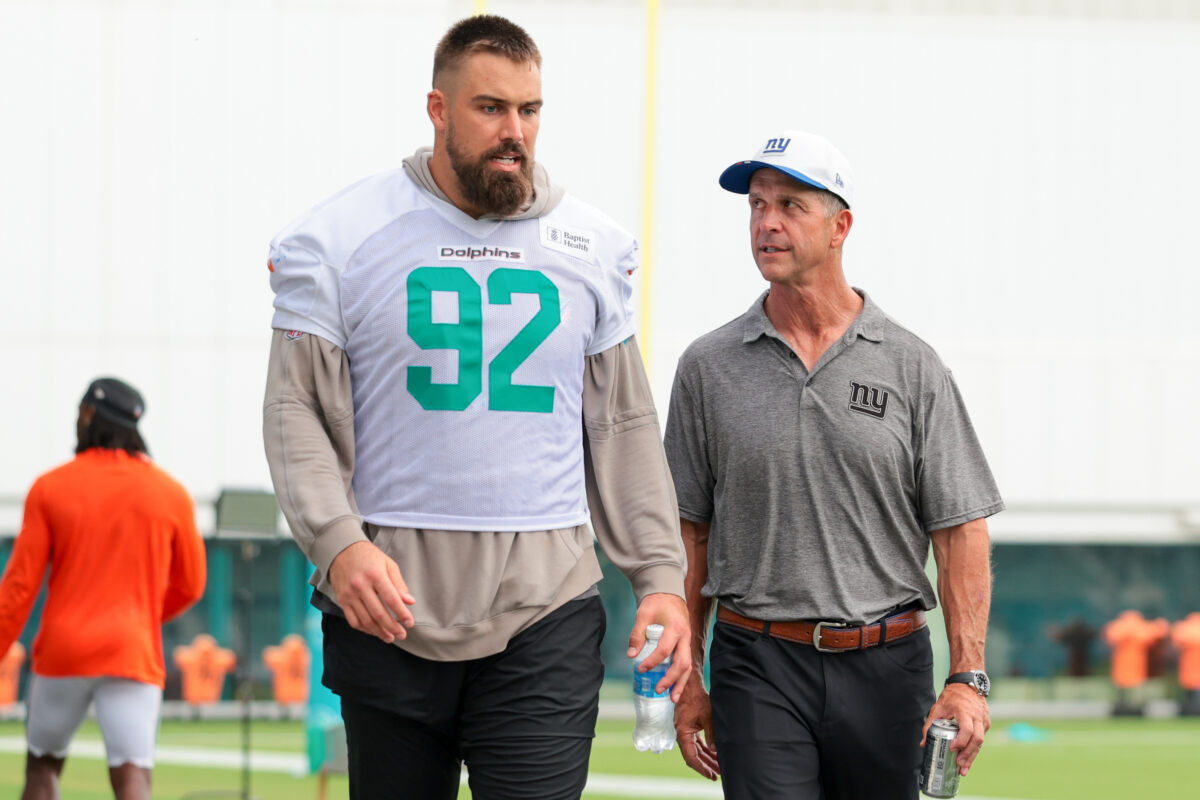 Aug 20, 2026; Miami Gardens, FL, USA; New York Giants head coach John Harbaugh speaks to Miami Dolphins defensive tackle Zach Sieler (92) after joint practice at Baptist Health Training Complex. Mandatory Credit: Sam Navarro-Imagn Images
