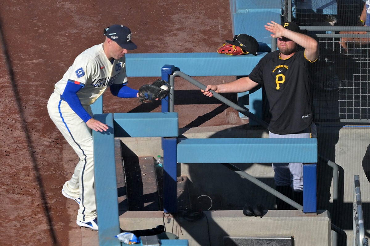 Aug 22, 2026; Los Angeles, California, USA; Los Angeles Dodgers first baseman Freddie Freeman (5) catches a foul ball off Pittsburgh Pirates shortstop Jared Triolo (19) at the edge of the dugout steps in the fourth inning at Dodger Stadium. Mandatory Credit: Jayne Kamin-Oncea-Imagn Images