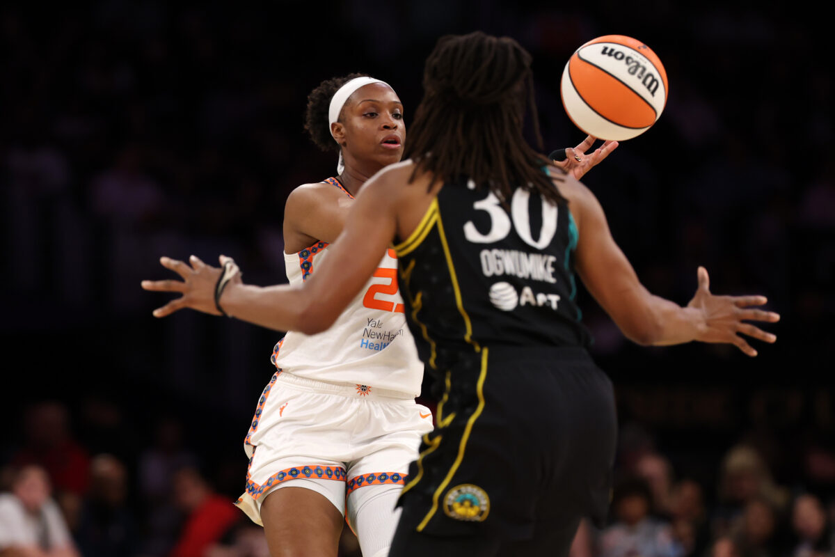 Aug 22, 2026; Los Angeles, California, USA;  Connecticut Sun guard Kennedy Burke (25) passes the ball against Los Angeles Sparks forward Nneka Ogwumike (30) during the third quarter at Crypto.com Arena. Mandatory Credit: Kiyoshi Mio-Imagn Images