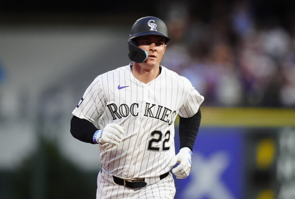 Aug 22, 2026; Denver, Colorado, USA;  Colorado Rockies outfielder Mickey Moniak (22) hits a home run during the fifth inning against the Cleveland Guardians at Coors Field.  Mandatory Credit: Ron Chenoy-Imagn Images