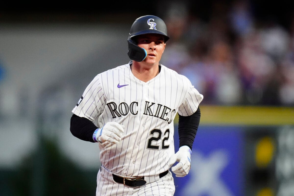 Aug 22, 2026; Denver, Colorado, USA;  Colorado Rockies outfielder Mickey Moniak (22) hits a home run during the fifth inning against the Cleveland Guardians at Coors Field.  Mandatory Credit: Ron Chenoy-Imagn Images