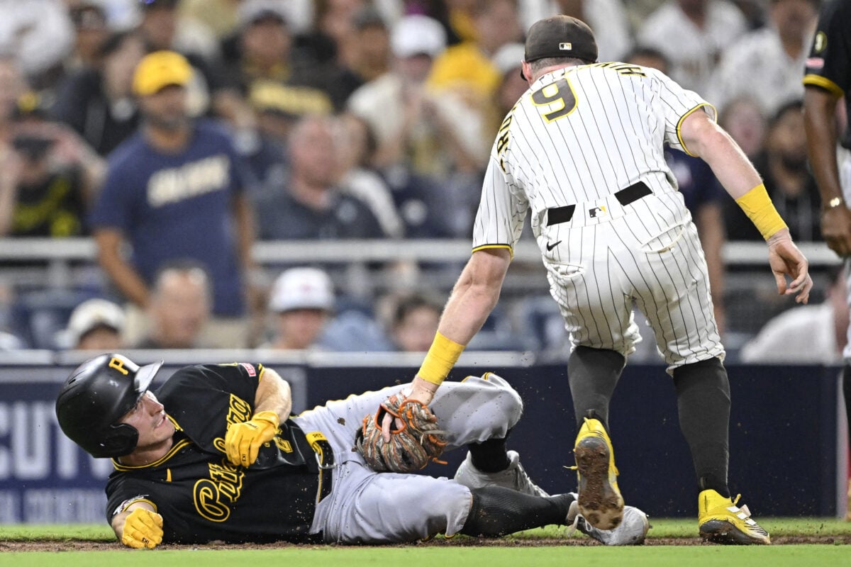 Aug 24, 2026; San Diego, California, USA;  Pittsburgh Pirates center fielder Jake Mangum (28) is tagged out by San Diego Padres second baseman Jake Cronenworth (9) after being caught in a run down during the tenth inning at Petco Park.  Mandatory Credit: Denis Poroy-Imagn Images