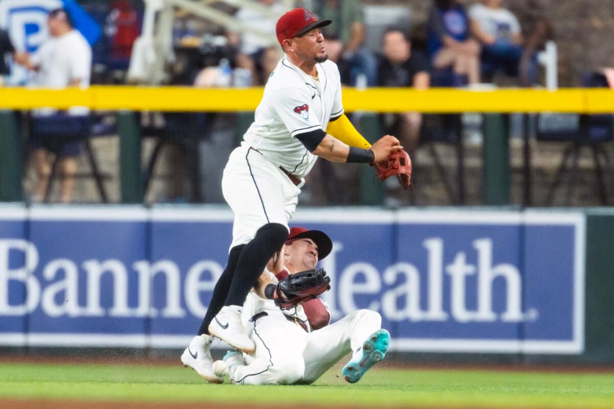 Aug 25, 2026; Phoenix, Arizona, USA; Arizona Diamondbacks second baseman Ildemaro Vargas (top) collides with outfielder Corbin Carroll as they attempt to catch a fly ball in the sixth inning against the Chicago Cubs at Chase Field. Mandatory Credit: Mark J. Rebilas-Imagn Images