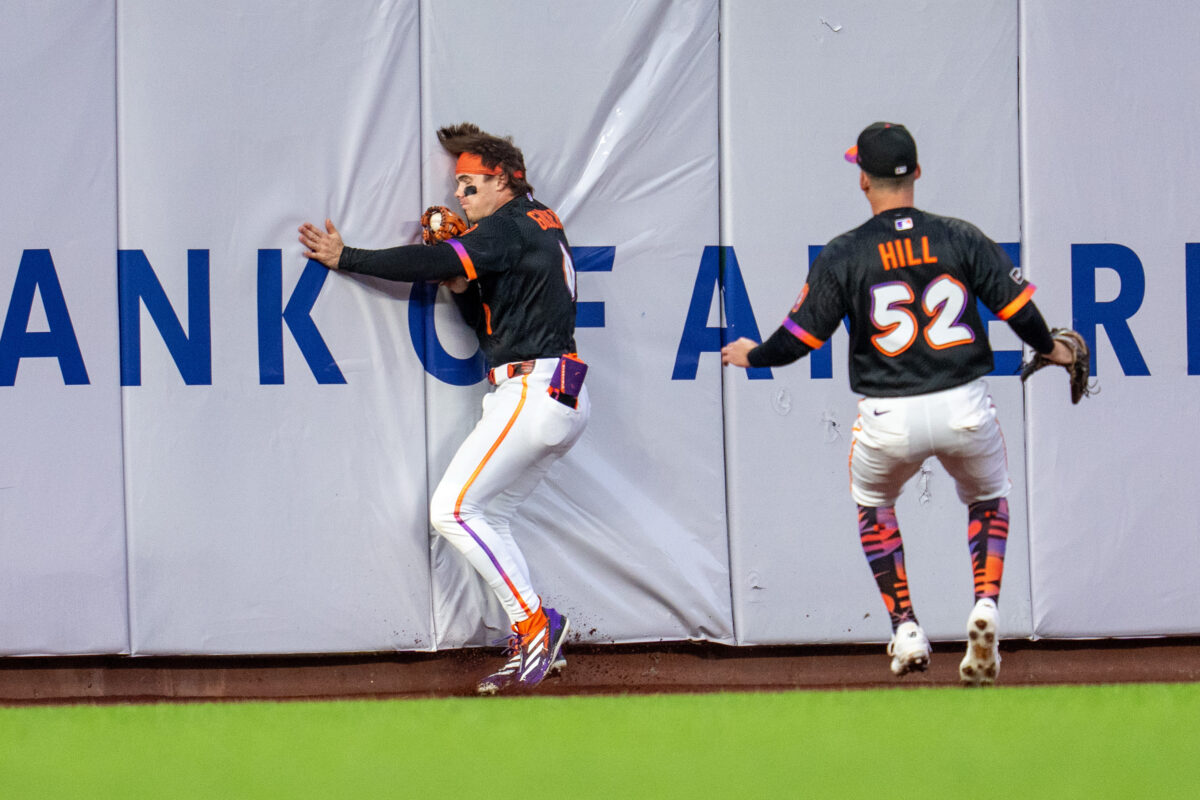 Aug 25, 2026; San Francisco, California, USA;  San Francisco Giants center fielder Drew Gilbert (0) after the catch runs into the outfield wall against the Cincinnati Reds during the fourth inning at Oracle Park.  Mandatory Credit: Neville E. Guard-Imagn Images