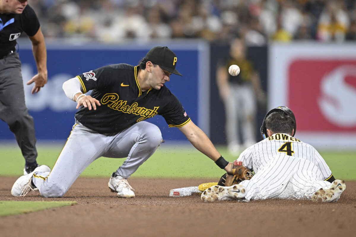 Aug 25, 2026; San Diego, California, USA;  San Diego Padres right fielder Jase Bowen (4) steals second base as Pittsburgh Pirates shortstop Jacob Gonzalez (26) loses the ball during the ninth inning at Petco Park.  Mandatory Credit: Denis Poroy-Imagn Images
