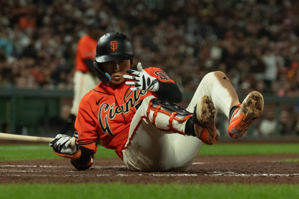 Aug 28, 2026; San Francisco, California, USA;  San Francisco Giants right fielder Jung Hoo Lee (51) falls during the fifth inning against the Arizona Diamondbacks at Oracle Park.  Mandatory Credit: Stan Szeto-Imagn Images