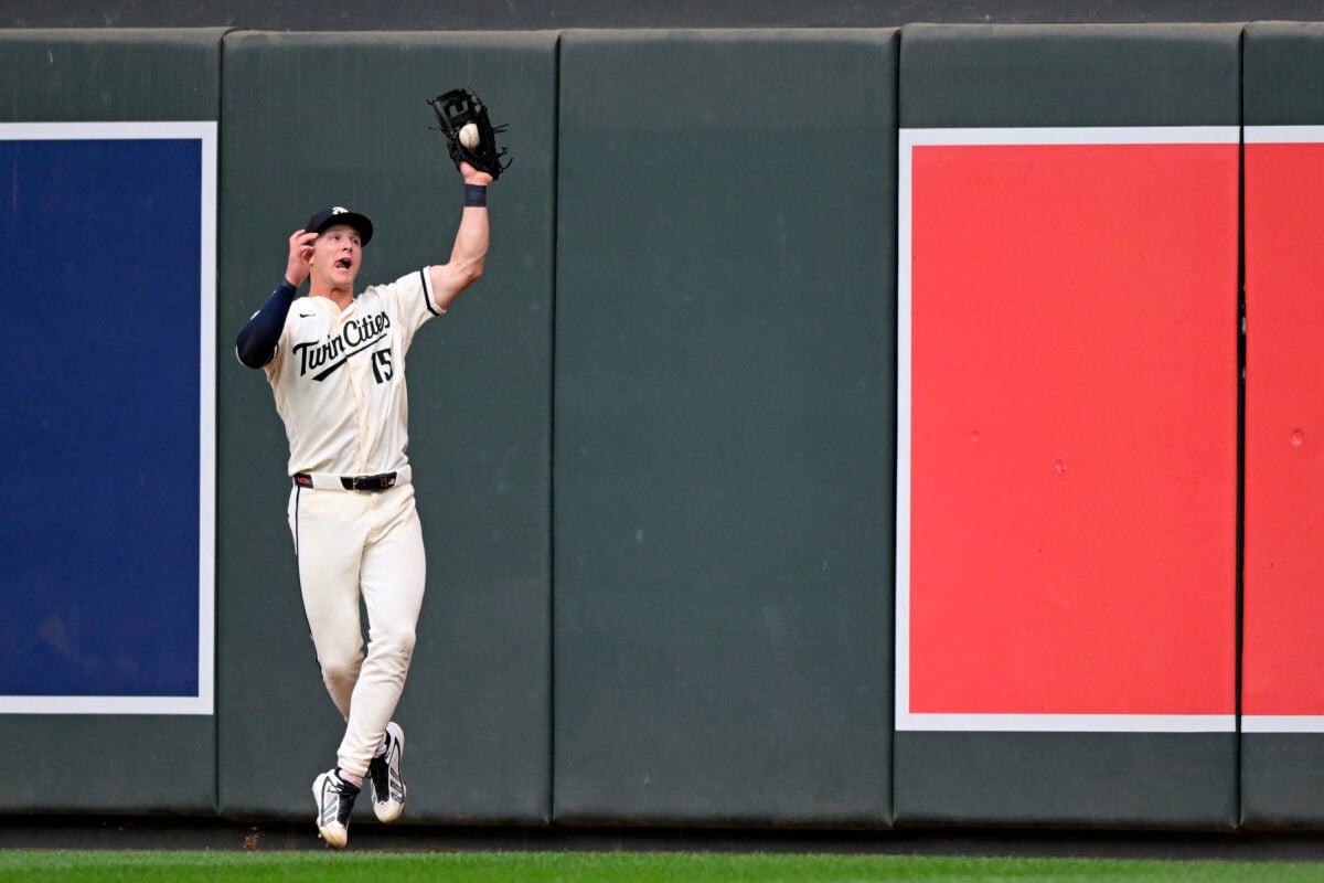 Aug 29, 2026; Minneapolis, Minnesota, USA;  Minnesota Twins outfielder Luke Keaschall (15) makes a leaping catch on a fly ball against the Chicago White Sox during the ninth inning at Target Field.  Mandatory Credit: Nick Wosika-Imagn Images