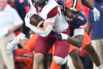 Sep 12, 2025; Syracuse, New York, USA; Colgate Raiders running back Cole Fulton (28) is tackled by Syracuse Orange defensive lineman Denis Jaquez Jr. (11) in the third quarter at the JMA Wireless Dome. Mandatory Credit: Mark Konezny-Imagn Images