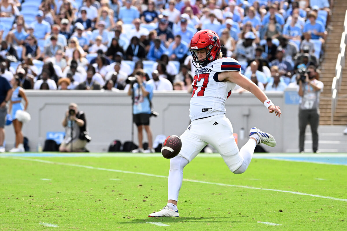 Sep 13, 2025; Chapel Hill, North Carolina, USA; Richmond Spiders punter Ned Gray (37) punts in the first quarter at Kenan Stadium. Mandatory Credit: Bob Donnan-Imagn Images