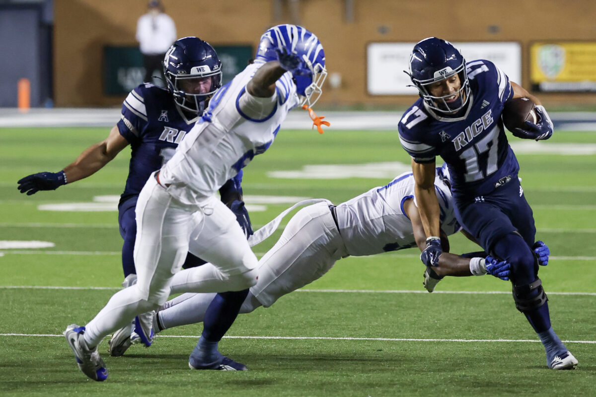 Oct 31, 2025; Houston, Texas, USA; Rice Owls wide receiver Landon Ransom-Goelz (17) is tackled by Memphis Tigers linebacker Demarco Ward (31) in the second half at Rice Stadium. Mandatory Credit: Thomas Shea-Imagn Images