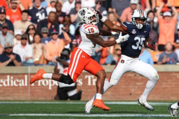 Nov 22, 2025; Auburn, Alabama, USA;  Auburn Tigers running back Justin Jones (35) stiff arms Mercer Bears linebacker Julian Fox (10) during the second quarter at Jordan-Hare Stadium. Mandatory Credit: John Reed-Imagn Images