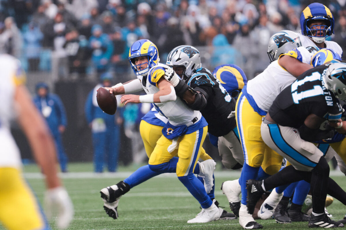 Nov 30, 2025; Charlotte, North Carolina, USA; Los Angeles Rams quarterback Matthew Stafford (9) is sacked by Carolina Panthers defensive end Derrick Brown (95) during the fourth quarter at Bank of America Stadium. Mandatory Credit: Scott Kinser-Imagn Images