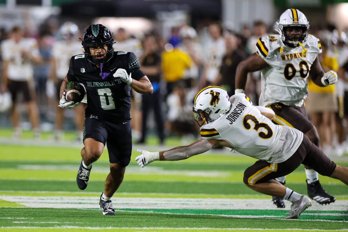 Nov 29, 2025; Honolulu, Hawaii, USA; Wyoming Cowboys defensive back Andrew Johnson (3) can’t pull down Hawaii Rainbow Warriors running back Cam Barfield (0) during the third quarter at Clarence T.C. Ching Athletics Complex. Mandatory Credit: Marco Garcia-Imagn Images