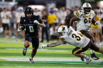 Nov 29, 2025; Honolulu, Hawaii, USA; Wyoming Cowboys defensive back Andrew Johnson (3) can’t pull down Hawaii Rainbow Warriors running back Cam Barfield (0) during the third quarter at Clarence T.C. Ching Athletics Complex. Mandatory Credit: Marco Garcia-Imagn Images