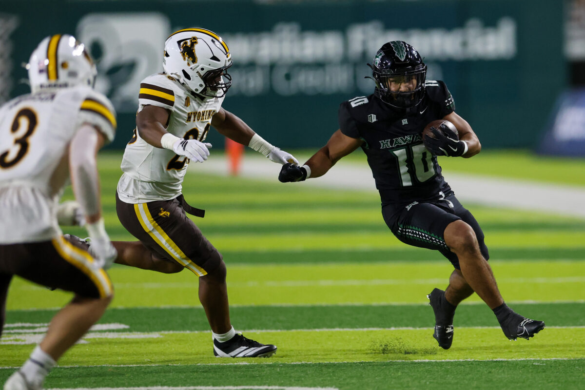 Nov 29, 2025; Honolulu, Hawaii, USA; Hawaii Rainbow Warriors running back David Cordero (10) runs through the Wyoming Cowboys defense during the first quarter at Clarence T.C. Ching Athletics Complex. Mandatory Credit: Marco Garcia-Imagn Images