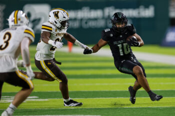 Nov 29, 2025; Honolulu, Hawaii, USA; Hawaii Rainbow Warriors running back David Cordero (10) runs through the Wyoming Cowboys defense during the first quarter at Clarence T.C. Ching Athletics Complex. Mandatory Credit: Marco Garcia-Imagn Images