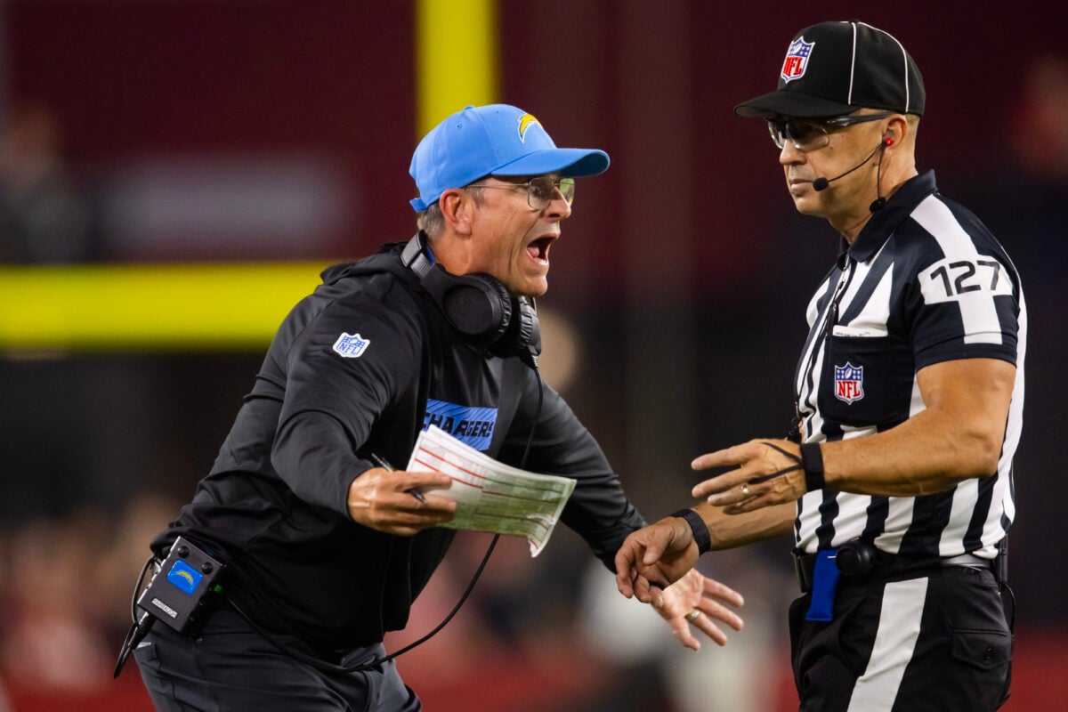 Oct 21, 2024; Glendale, Arizona, USA; Los Angeles Chargers head coach Jim Harbaugh argues with NFL umpire Scott Campbell against the Arizona Cardinals at State Farm Stadium. Mandatory Credit: Mark J. Rebilas-Imagn Images
