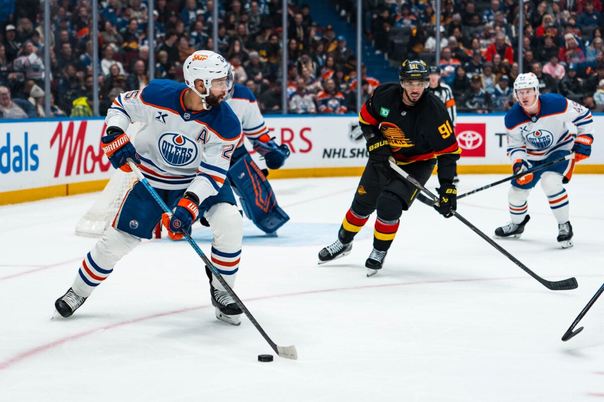 Jan 17, 2026; Vancouver, British Columbia, CAN; Vancouver Canucks forward Evander Kane (91) watches Edmonton Oilers defenseman Darnell Nurse (25) handle the puck in the second period at Rogers Arena. Mandatory Credit: Bob Frid-Imagn Images