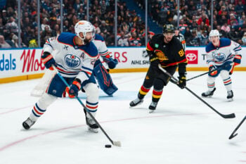 Jan 17, 2026; Vancouver, British Columbia, CAN; Vancouver Canucks forward Evander Kane (91) watches Edmonton Oilers defenseman Darnell Nurse (25) handle the puck in the second period at Rogers Arena. Mandatory Credit: Bob Frid-Imagn Images