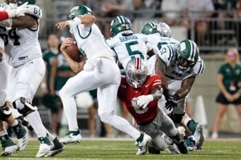 Ohio State Buckeyes linebacker Arvell Reese (8) hits Ohio Bobcats quarterback Nick Poulos (8) during the first half of the NCAA football game at Ohio Stadium on Sept. 13, 2025.
