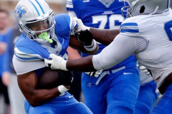 Middle Tennessee State running back Brooklen Davis (33) carries the ball as Middle Tennessee State defensive tackle Justin Bodford (90) makes the stop during Middle Tennessee State University's spring football practice on Friday, April 24, 2026.