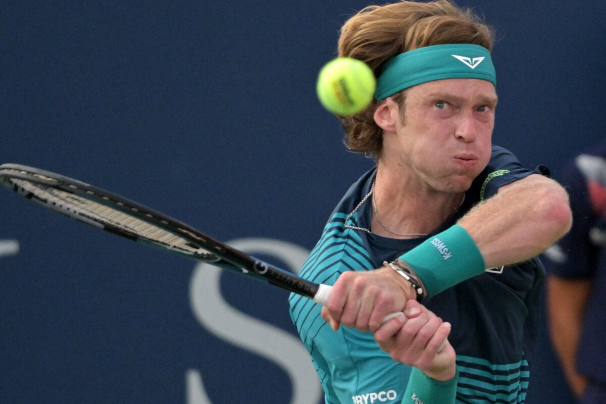 Aug 4, 2026; Montreal, QC, Canada; Andrey Rublev hits a backhand against Juncheng Shang (CHN) during second round play at IGA Stadium. Mandatory Credit: Eric Bolte-Imagn Images