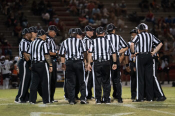 The referees meet at midfield prior to the West Florida vs Pace preseason football game at Pace High School on Aug. 13, 2026.