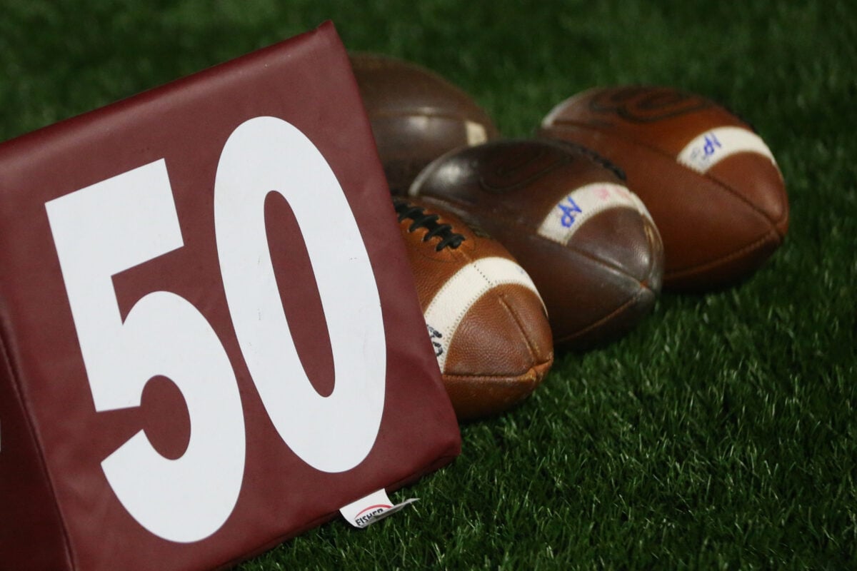 A 50-yard marker and footballs are pictured in this file photo.