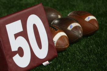A 50-yard marker and footballs are pictured in this file photo.