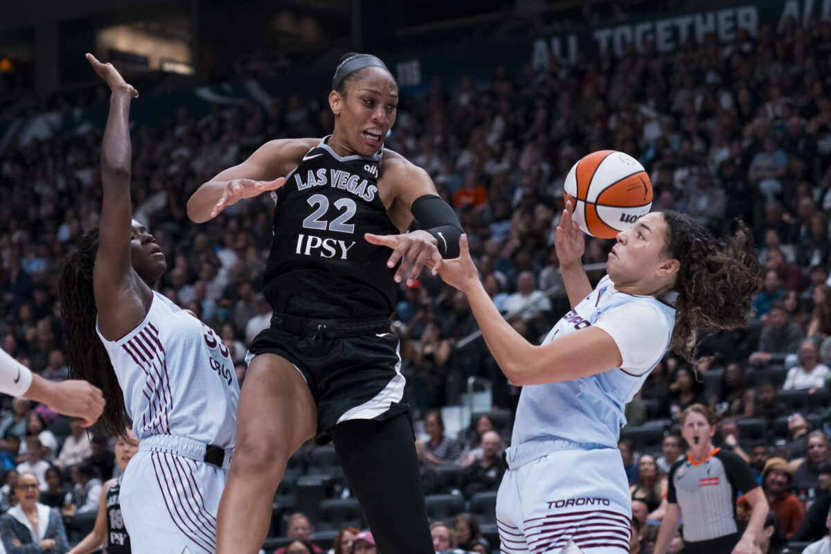 Aug 23, 2026; Vancouver, British Columbia, CAN;  Las Vegas Aces center A'ja Wilson (22) battles for the rebound against Toronto Tempo forward Ornella Bankole (33) and guard Kiki Rice (1) in the second half at Rogers Arena.  Mandatory Credit: Bob Frid-Imagn Images