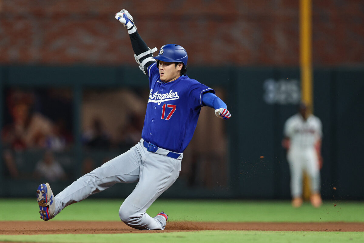 Aug 26, 2026; Cumberland, Georgia, USA;  Los Angeles Dodgers designated hitter Shohei Ohtani (17) slides into second base against the Atlanta Braves in the seventh inning at Truist Park.  Mandatory Credit: Colin Hubbard-Imagn Images