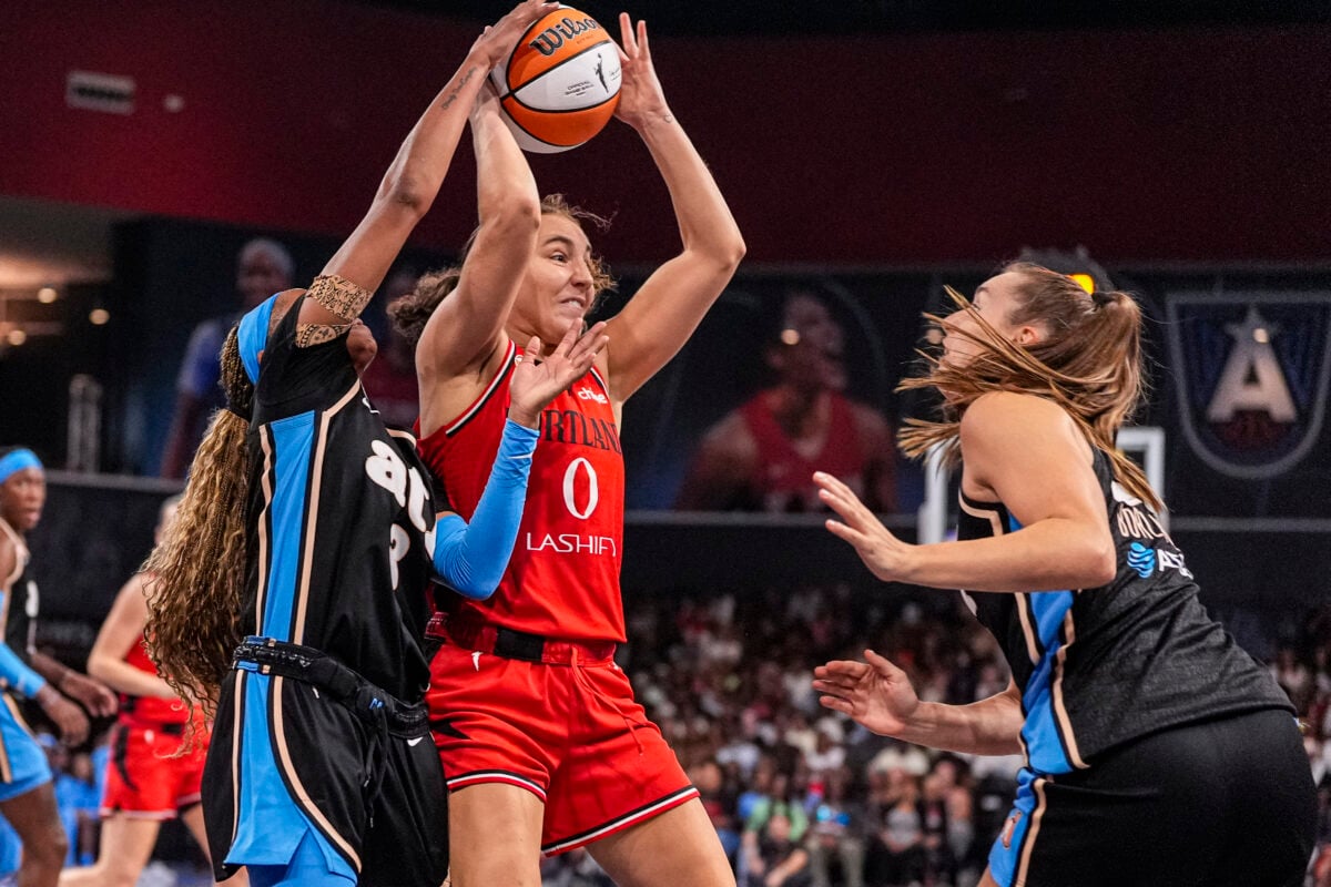 Aug 28, 2026; College Park, Georgia, USA; Portland Fire guard Carla Leite (0) controls the ball over Atlanta Dream guard Jordin Canada (3) during the first half at Gateway Center Arena at College Park. Mandatory Credit: Dale Zanine-Imagn Images