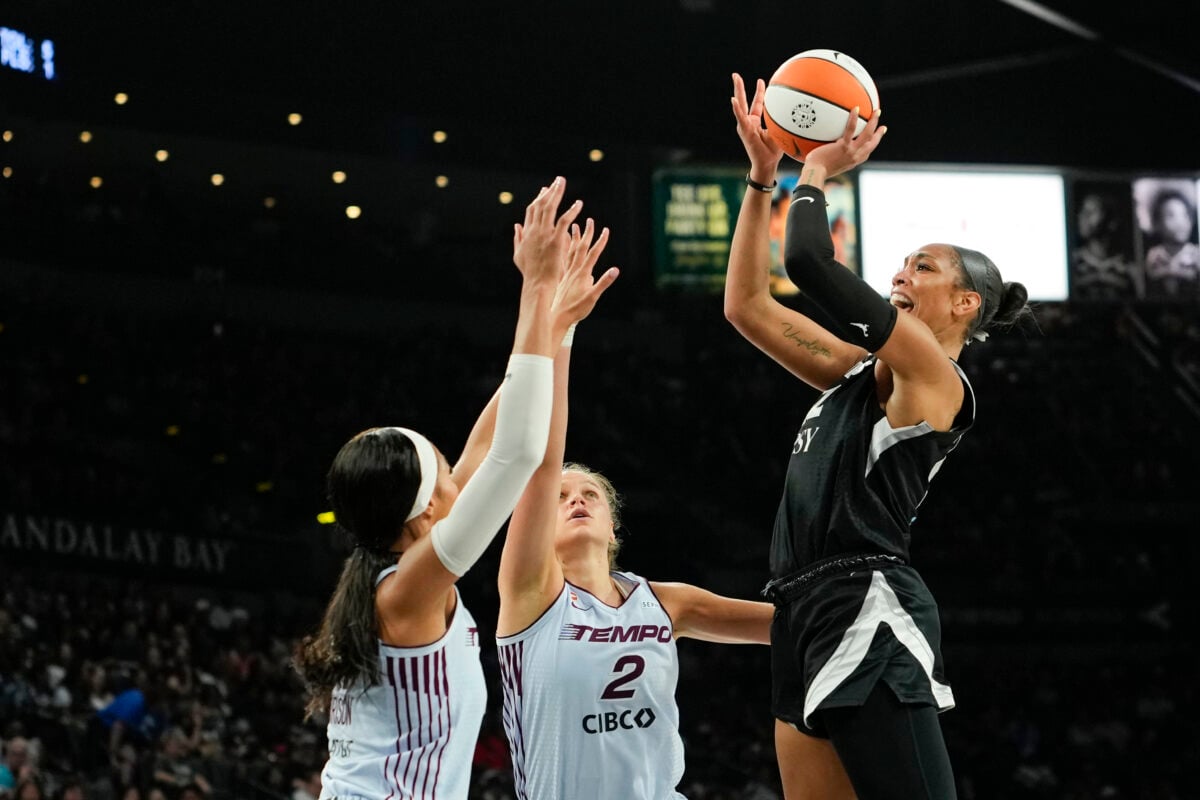 Aug 28, 2026; Las Vegas, Nevada, USA;  Las Vegas Aces center A'ja Wilson (22) shoots the ball against Toronto Tempo forwards Isabelle Harrison (21) and Laura Juskaite (2) during the second quarter of a WNBA basketball game at Michelob Ultra Arena.  Mandatory Credit: Lucas Peltier-Imagn Images