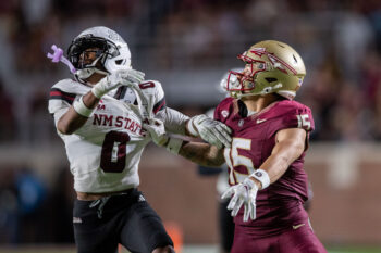 Florida State Seminoles defensive lineman Rylan Kennedy (15)  and New Mexico State Aggies running back TJ Washington Jr. (0) eye the ball as it soars through the air. The Florida State Seminoles defeated the New Mexico State Aggies 34-17 at Doak Campbell Stadium on Saturday, Aug. 29, 2026.