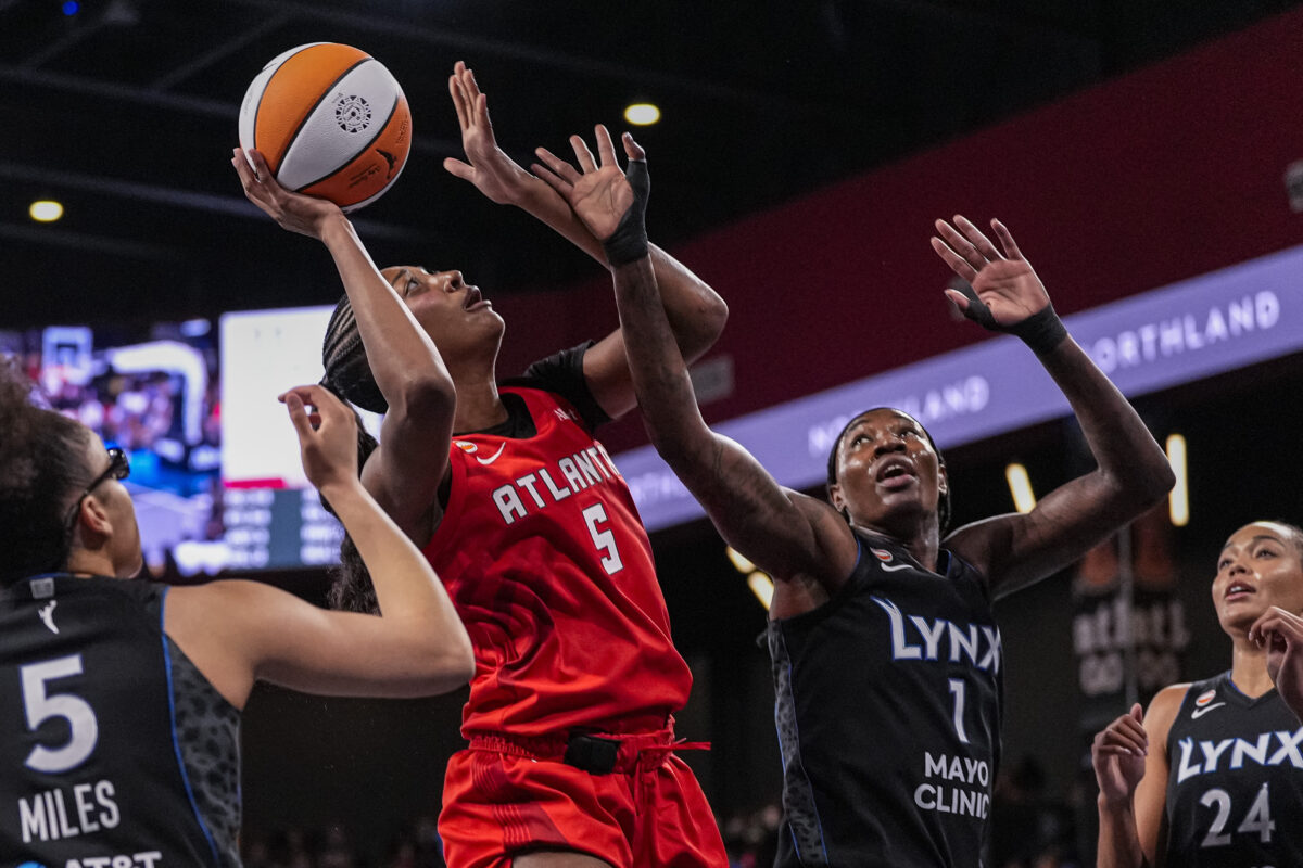 Aug 30, 2026; College Park, Georgia, USA; Atlanta Dream forward Angel Reese (5) shoots over Minnesota Lynx forward Natasha Howard (1) during the first half at Gateway Center Arena at College Park. Mandatory Credit: Dale Zanine-Imagn Images