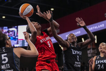 Aug 30, 2026; College Park, Georgia, USA; Atlanta Dream forward Angel Reese (5) shoots over Minnesota Lynx forward Natasha Howard (1) during the first half at Gateway Center Arena at College Park. Mandatory Credit: Dale Zanine-Imagn Images