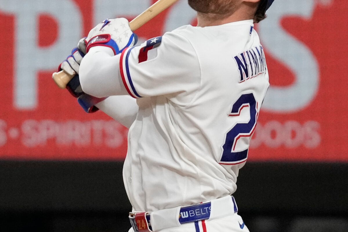 Aug 31, 2026; Arlington, Texas, USA;  Texas Rangers right fielder Brandon Nimmo (24) hits a run scoring sacrifice fly against the Athletics during the fifth inning at Globe Life Field. Mandatory Credit: Raymond Carlin III-Imagn Images
