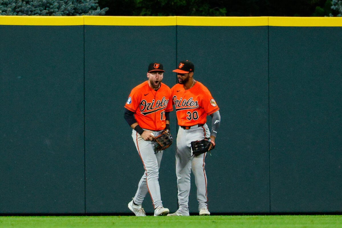 Aug 31, 2026; Denver, Colorado, USA; Baltimore Orioles center fielder Colton Cowser (17) reacts with right fielder Leody Taveras (30) after making a catch at the fence in the ninth inning against the Colorado Rockies at Coors Field. Mandatory Credit: Isaiah J. Downing-Imagn Images