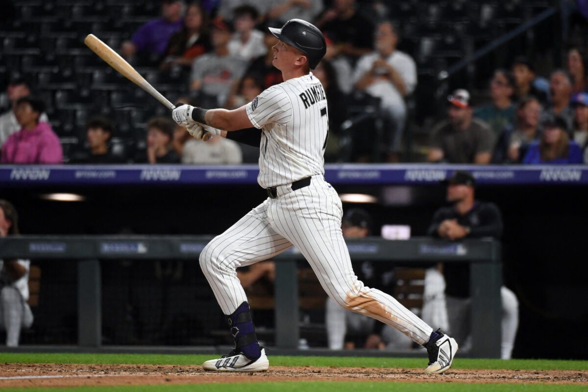 Sep 1, 2026; Denver, Colorado, USA; Colorado Rockies infielder TJ Rumfield (7) hits a home run in the seventh inning against the Baltimore Orioles at Coors Field. Mandatory Credit: Christopher Hanewinckel-Imagn Images
