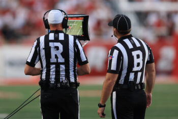 Sep 3, 2026; Salt Lake City, Utah, USA;  Referees review a play on the sidelines monitor during the first quarter of the game between the Utah Utes and against the Idaho Vandals at Rice-Eccles Stadium.  Mandatory Credit: Rob Gray-Imagn Images