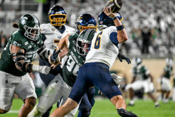 Michigan State’s Eli Coenen, left, pressures Toledo’s John Alan Richter during the third quarter on Friday, Sept. 4, 2026, at Spartan Stadium in East Lansing.
