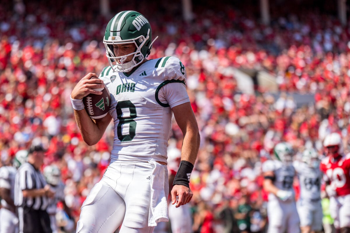 Sep 5, 2026; Lincoln, Nebraska, USA; Ohio Bobcats quarterback Nick Poulos (8) scores a touchdown against the Nebraska Cornhuskers during the fourth quarter at Memorial Stadium. Mandatory Credit: Dylan Widger-Imagn Images