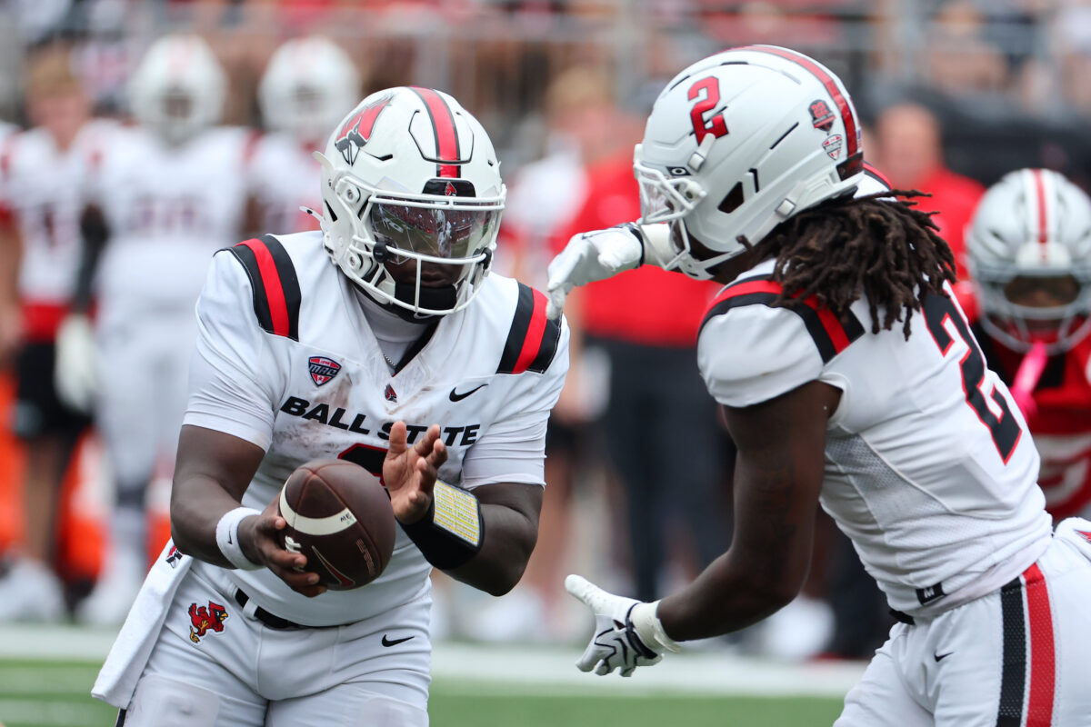 Sep 5, 2026; Columbus, Ohio, USA; Ball State Cardinals quarterback Keldric Luster (6) hands off to running back Jalen Bonds (2) during the third quarter against the Ohio State Buckeyes at Ohio Stadium. Mandatory Credit: Joseph Maiorana-Imagn Images