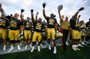 Sep 5, 2026; Annapolis, Maryland, USA;  United States Naval Academy superintendent Marine  Corps Lieutenant General Michael J. Borgschulte  and the Navy Midshipmen team celebrate after defeating Towson Tigers at Navy-Marine Corps Memorial Stadium. Mandatory Credit: Tommy Gilligan-Imagn Images