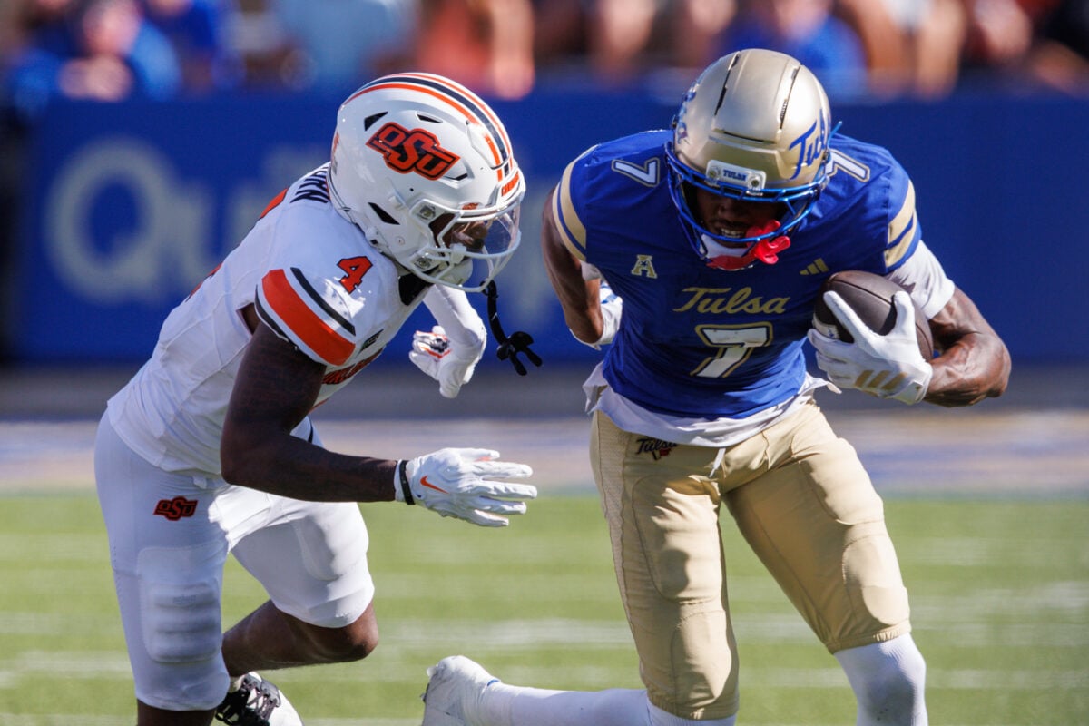 Sep 5, 2026; Tulsa, Oklahoma, USA; Tulsa Golden Hurricane wide receiver Jimmy Calloway (7) runs the ball around Oklahoma State Cowboys cornerback Mo Horn (4) during the second half at Skelly Field at H.A. Chapman Stadium. Mandatory Credit: William Purnell-Imagn Images