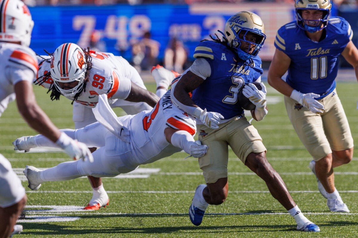 Sep 5, 2026; Tulsa, Oklahoma, USA; Oklahoma State Cowboys linebacker Tate Romney (3) dives for Tulsa Golden Hurricane running back Trequan Jones (3) during the second half at Skelly Field at H.A. Chapman Stadium. Mandatory Credit: William Purnell-Imagn Images