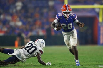 Sep 5, 2026; Gainesville, Florida, USA;  Florida Gators running back Duke Clark (20) runs with the ball while Florida Atlantic Owls defensive back Bo Simpson-Nealy (20) attempts to tackle during the second half at Ben Hill Griffin Stadium.  Mandatory Credit: Matt Pendleton-Imagn Images